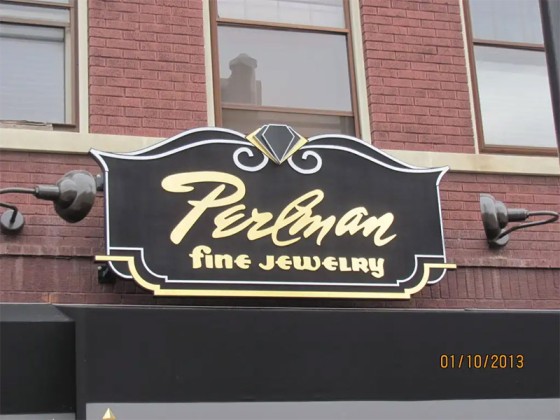 Jewelry store sign mounted on a building, indicating the shop's presence in Geneva, IL.